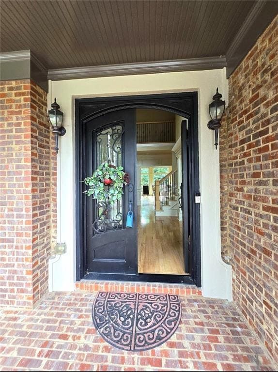 Doorway to property with brick siding