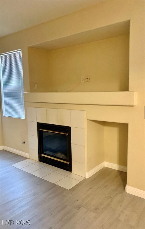 Detailed view of wood finished floors, a fireplace