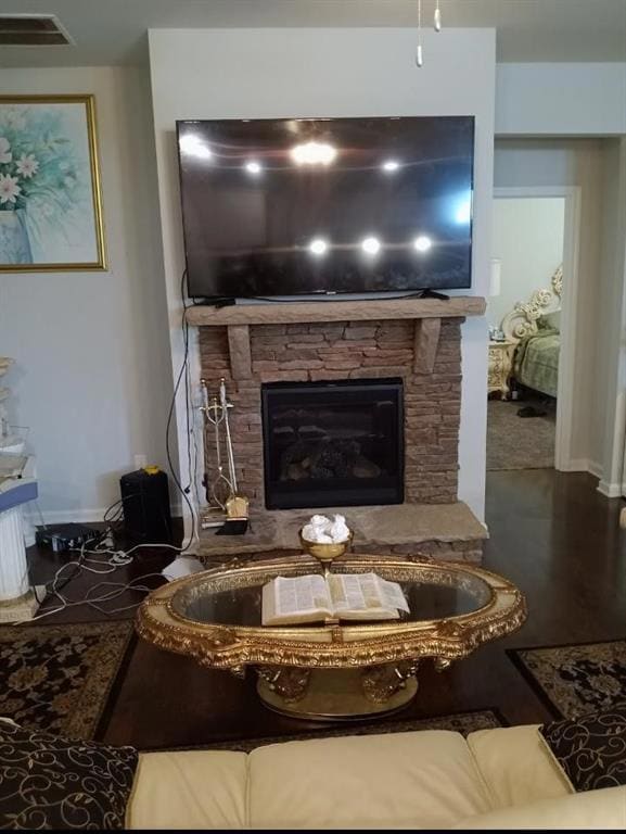 Living room featuring a stone fireplace