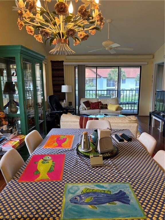 Dining space with wood finished floors and a ceili