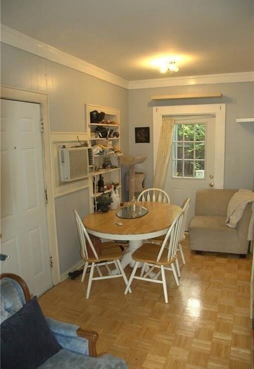 Dining room featuring ornamental molding and a wa
