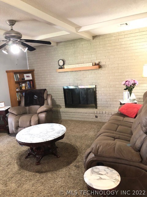 Fireplace is accented by a full brick wall and bea