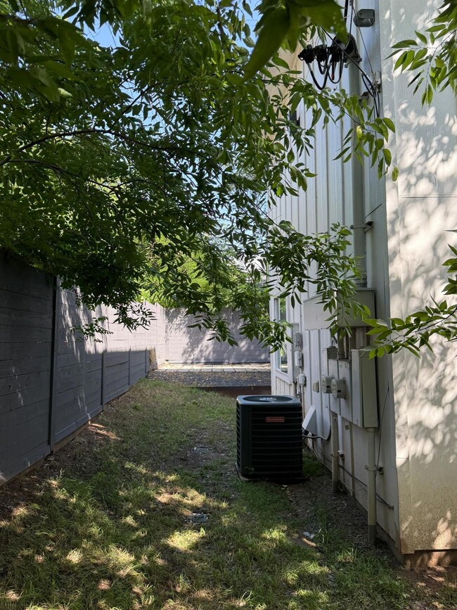 Fenced backyard featuring central AC unit