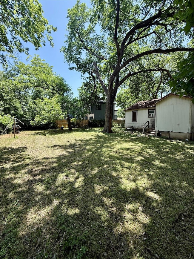 View of grassy yard featuring entry steps