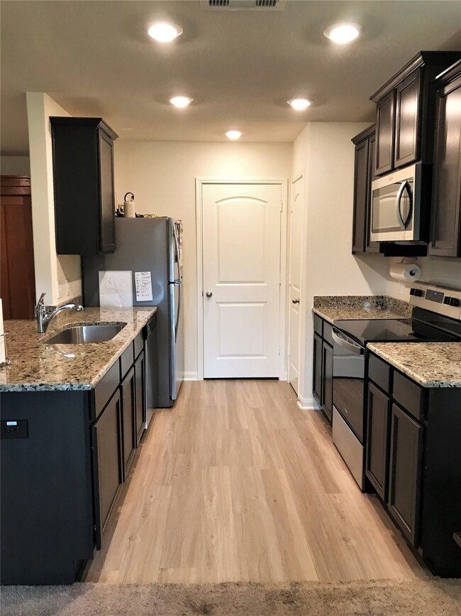 Polished granite counters and espresso stained cabinets, beautiful!