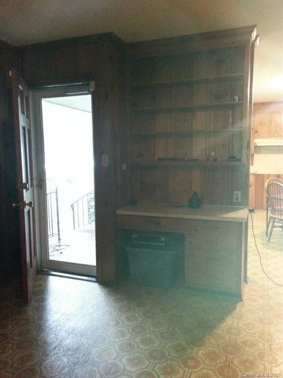 Large front porch entry to Den with custom built ins.