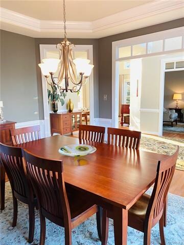 Formal Dining Room with tray ceiling and chandelie
