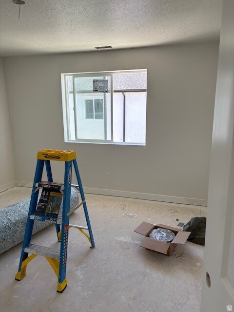 Empty room with a textured ceiling