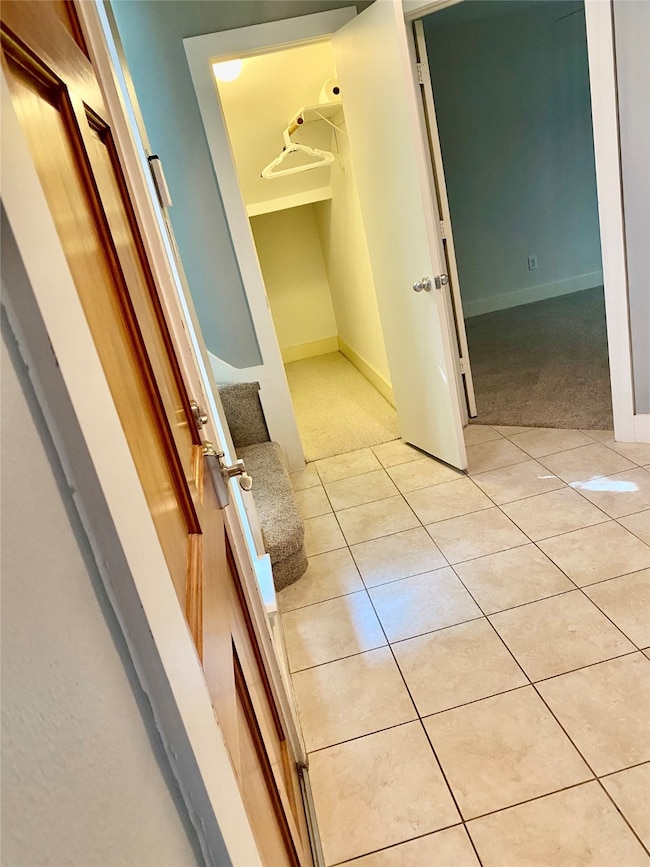 Tiled entry way; to the right you will find the two car garage; to the left and front, a full bed/bath and a wrapped-around coat and storage closet.   You could also convert this into a wine cellar/wine refrigerator.