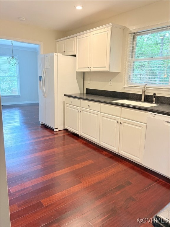 Kitchen featuring dishwasher, refrigerator, dark c