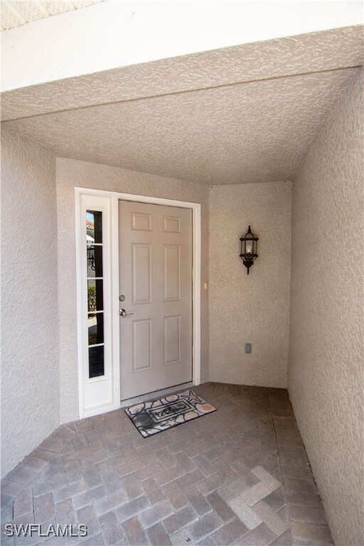 Private entry with a classic brick paved walkway.