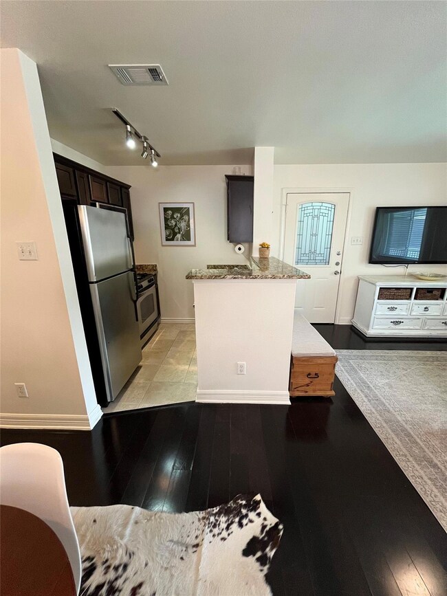 Kitchen with stainless steel appliances, light wo