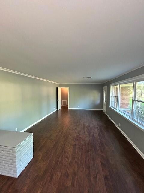Empty room with ornamental molding and dark hardwo