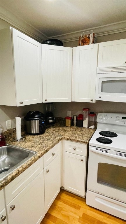 Kitchen featuring stone countertops, white applian