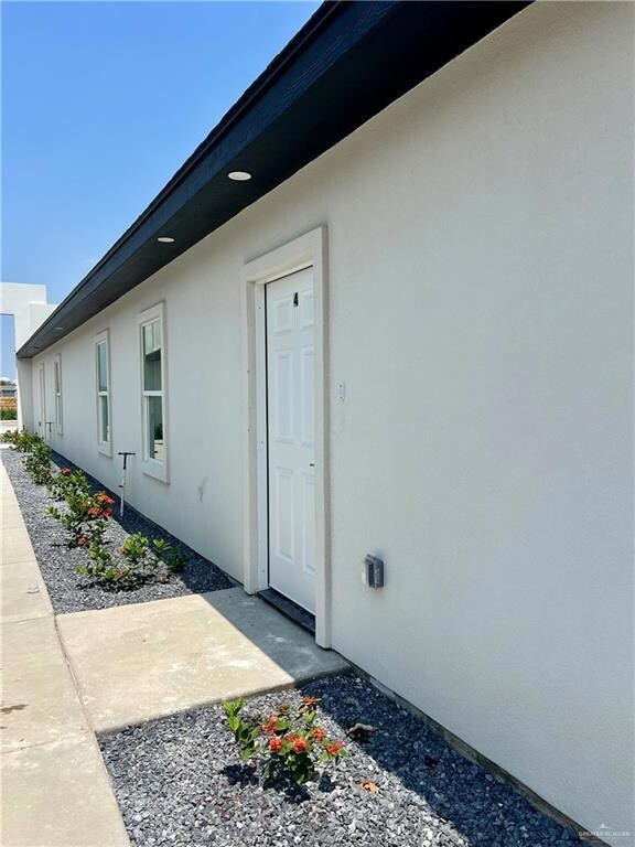 Entrance to property featuring stucco siding