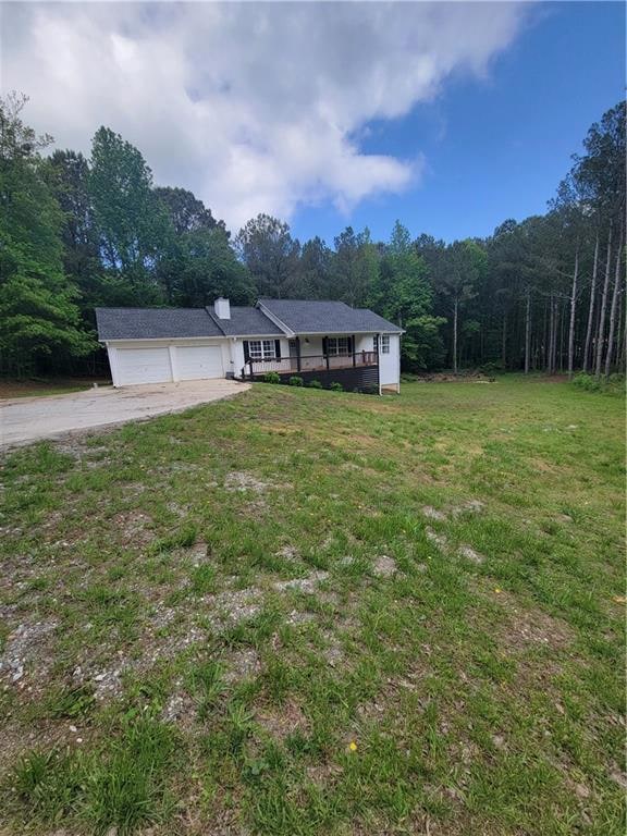Single story home with a garage, driveway, a front