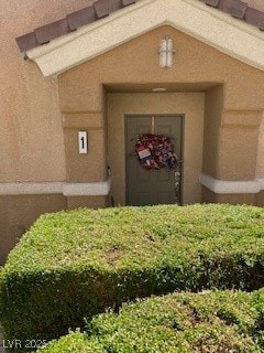 Property entrance with stucco siding