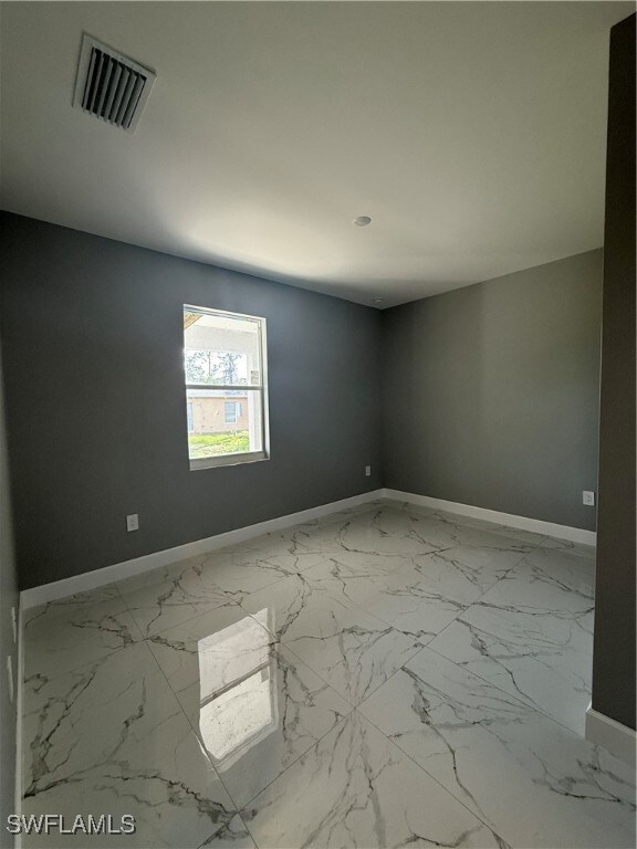 Empty room with marble look tiles