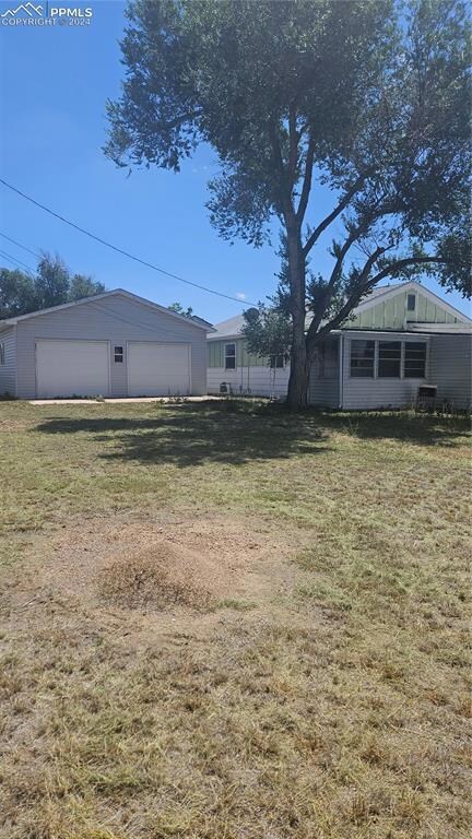 View of yard with a garage.  The entire area has a
