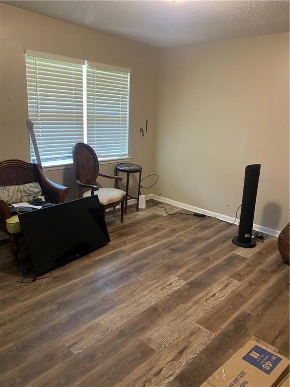 Living area featuring wood finished floors and baseboards