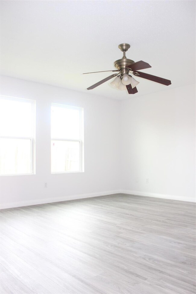 Unfurnished room featuring light hardwood / wood-style floors and ceiling fan