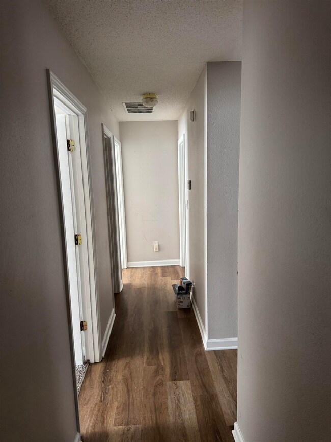 Hallway featuring dark hardwood / wood-style floor