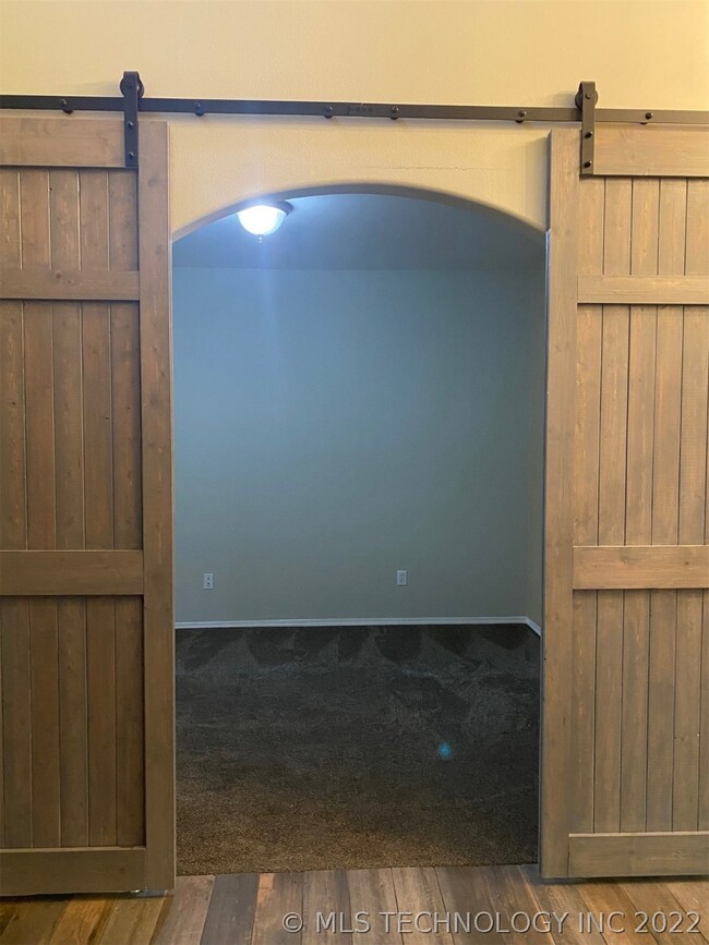 Large Office with barn doors and front window.