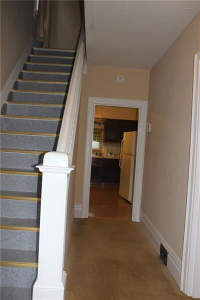 What a beautiful entry way! Notice the gorgeous detailed molding and banister