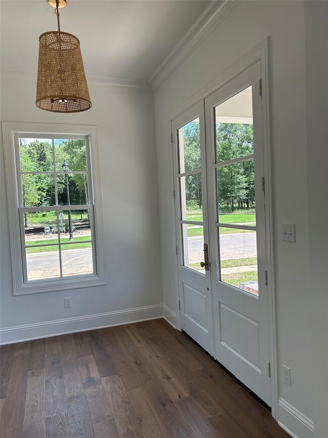 Doorway to outside with crown molding, french door