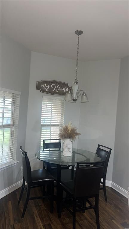 Dining room with baseboards, a notable chandelier,