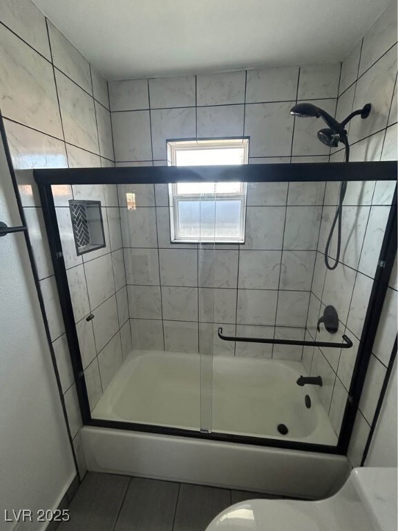 Full bathroom with combined bath / shower with gla