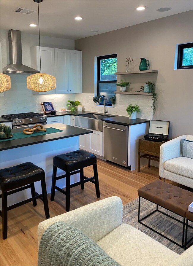 Kitchen featuring visible vents, dark countertops