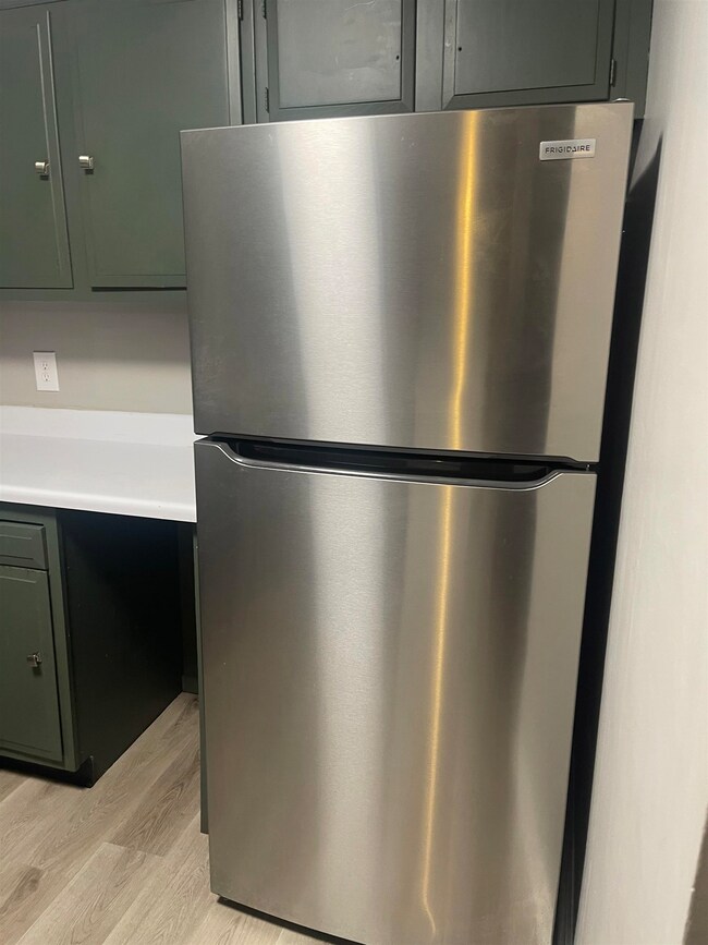 Detailed view of freestanding refrigerator and woo