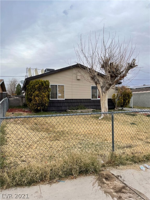 Front side yard. chain link fence rolling gate to