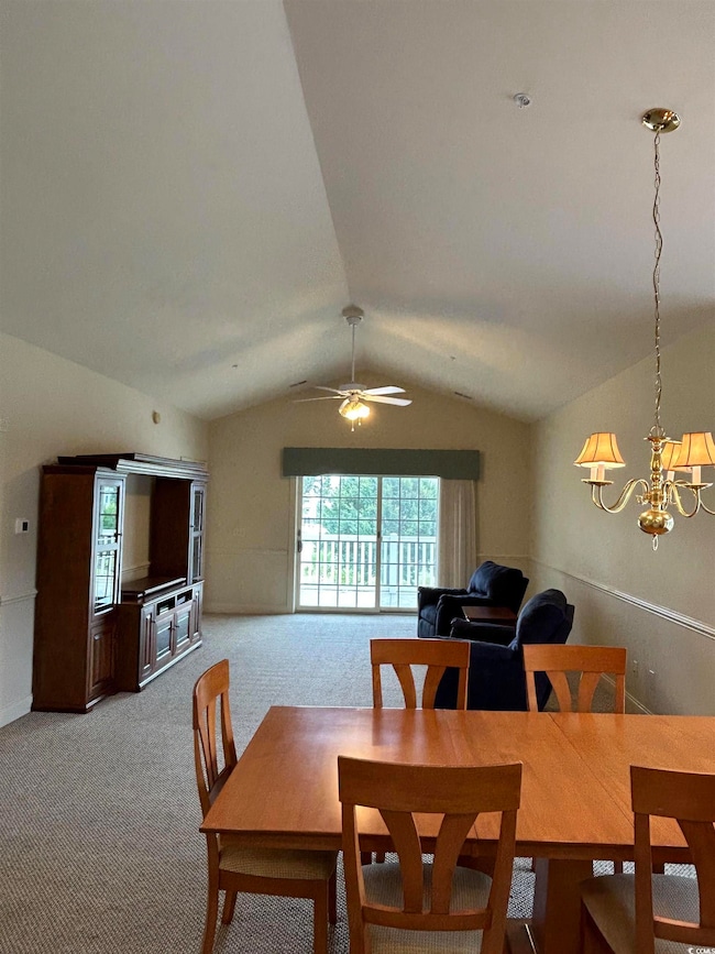 Dining room featuring vaulted ceiling, light color