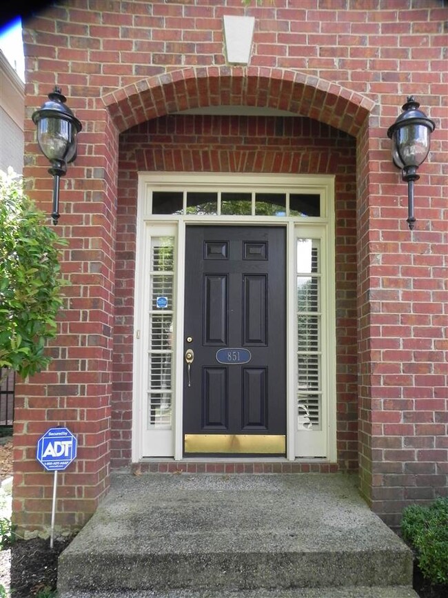 The recessed entryway with grand lighting and well