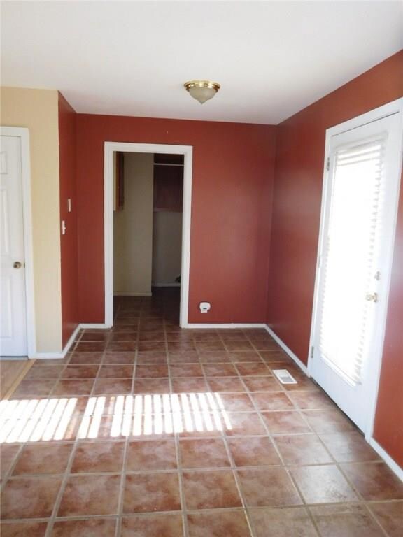 Eat in kitchen looking into laundry, door to right goes into HUGE fenced yard
