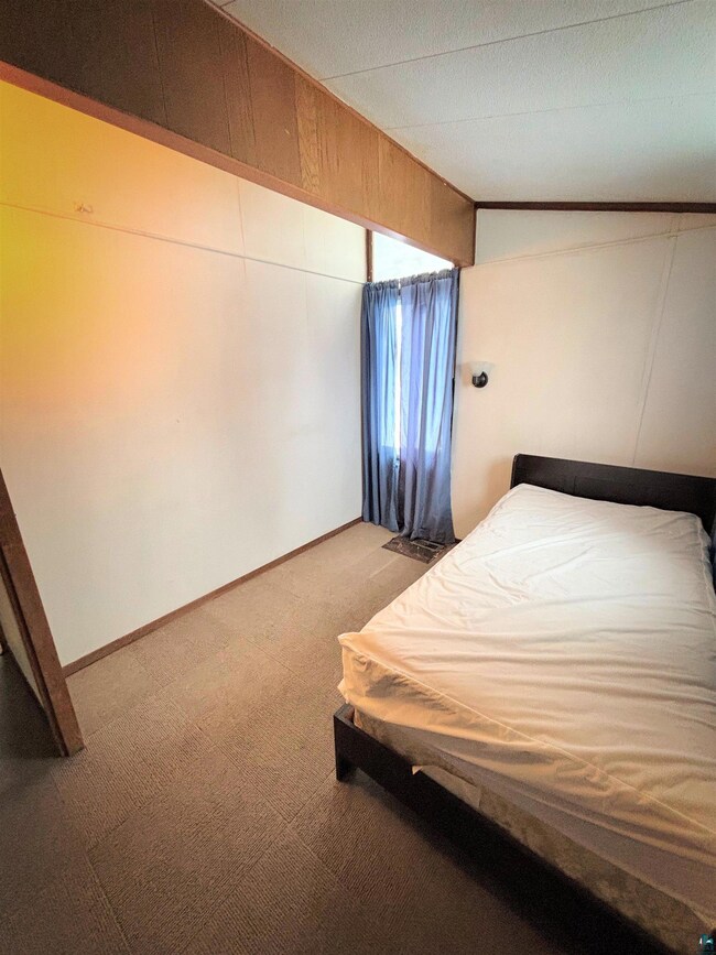 Unfurnished bedroom with baseboards, carpet floori