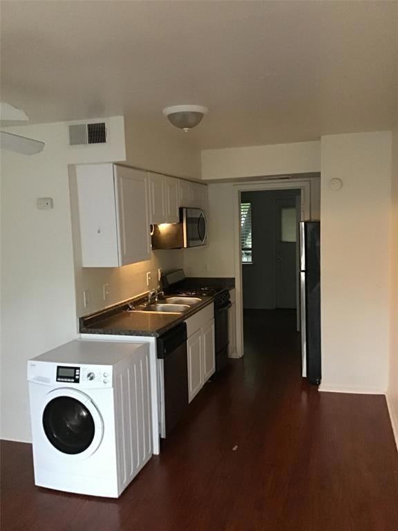 Kitchen featuring visible vents, dark countertops