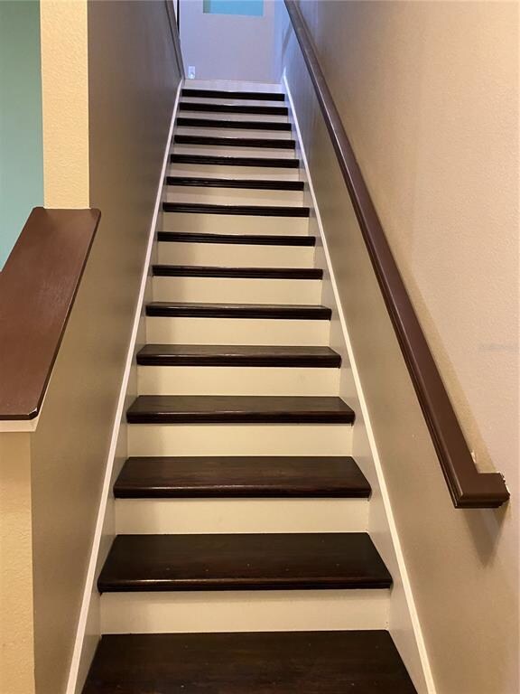 Wood stairs leading to bedrooms upstairs