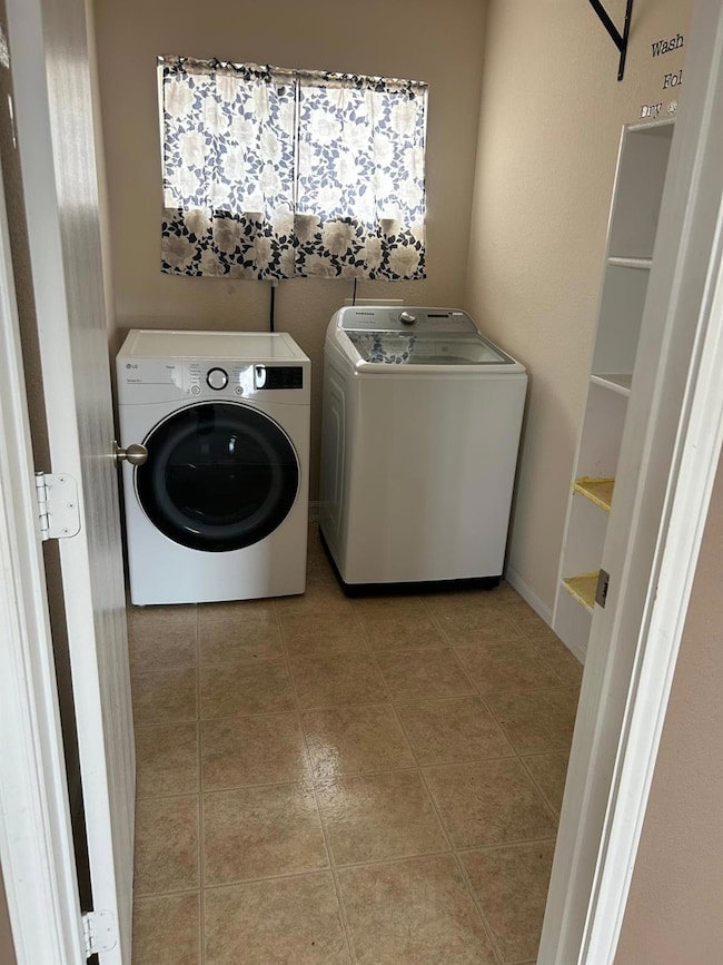 Washroom with washing machine and dryer and light