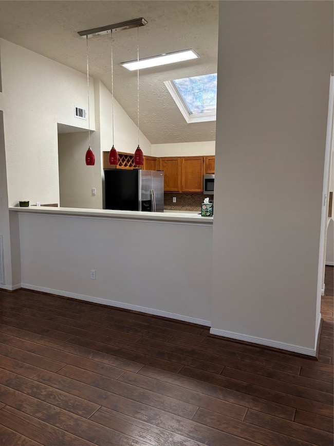 View from the living room into the kitchen-plenty of room for bar stools for additional seating.