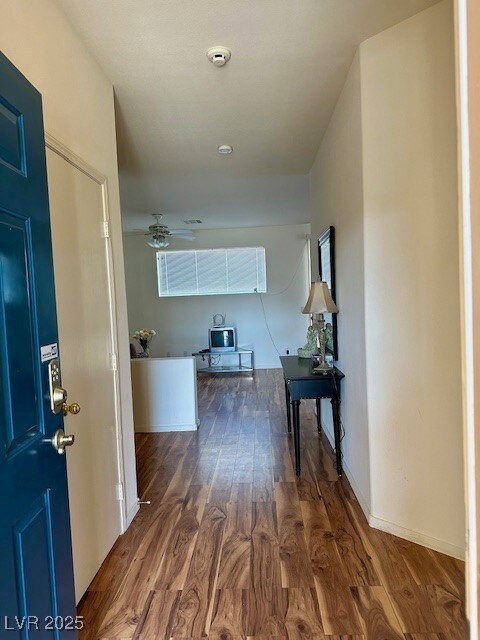 Hall featuring baseboards and wood finished floors