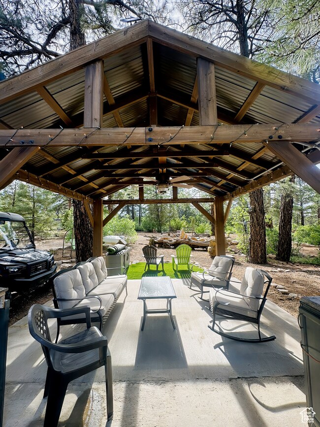 View of patio featuring a gazebo and an outdoor living space
