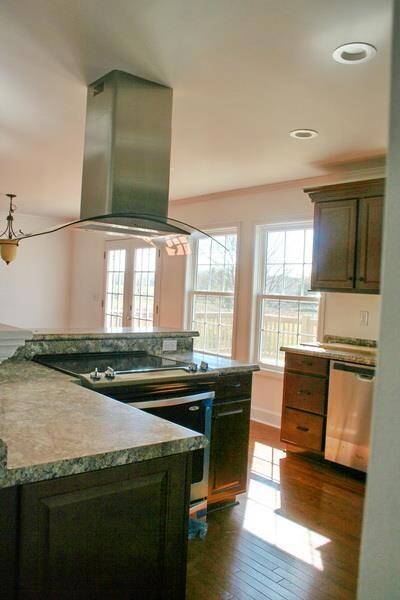 Unique glass vent hood with bar area and counter space.