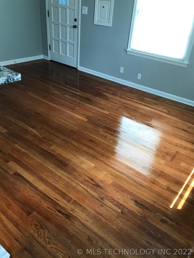 Light and bright living room.  Gleaming refinished