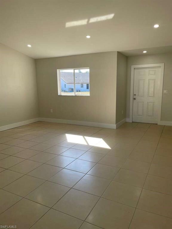 Empty room featuring recessed lighting and light tile patterned floors