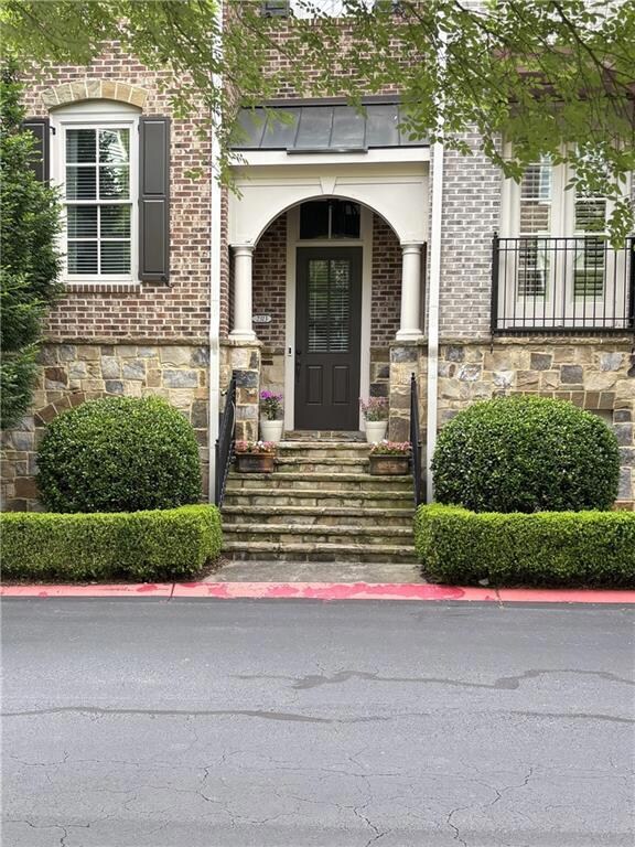 Spacious Entry with manicured landscape completes this luxurious Brownstone! City Living in the Suburbs!