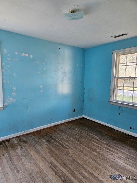 Unfurnished room featuring hardwood / wood-style f