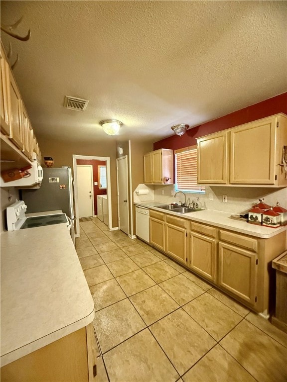 Kitchen with white appliances, washer and clothes